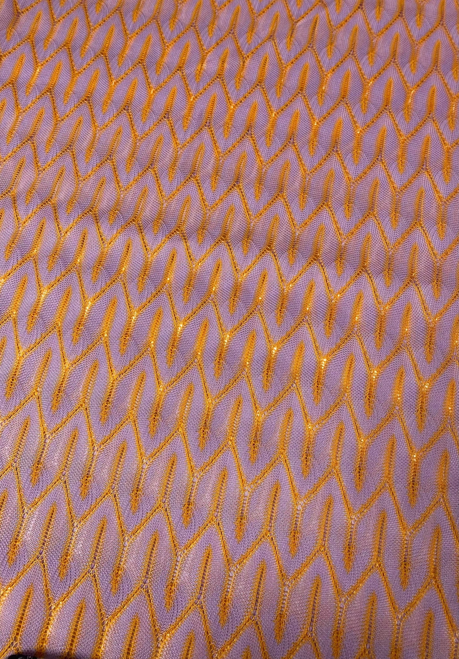 Zigzag knit jersey mesh fabric in lilac with orange zigzag pattern, lightweight and breathable textile for apparel and crafts