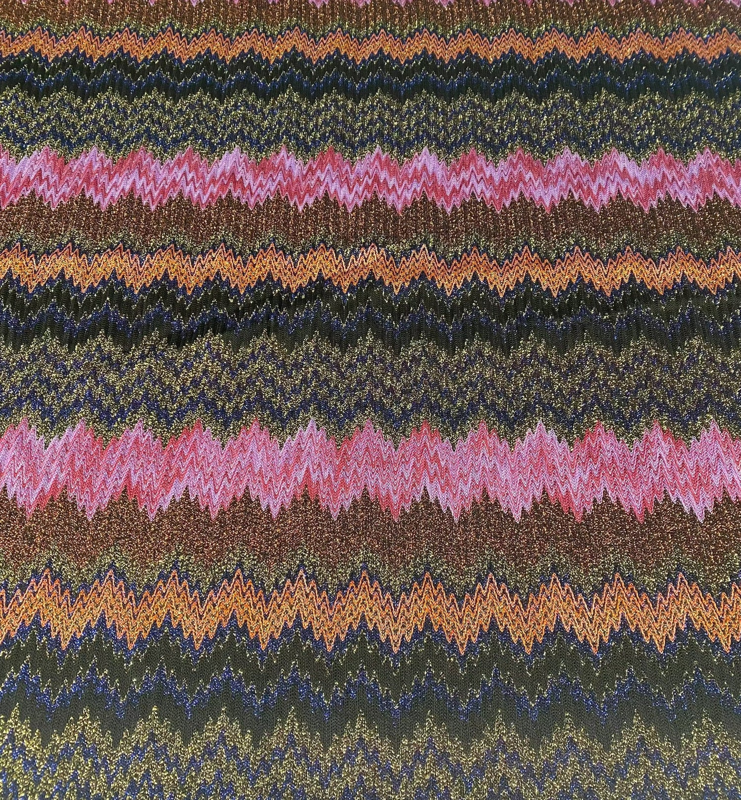 Glittery zigzag mesh knitted fabric with colorful shimmering pattern for crafting and fashion projects