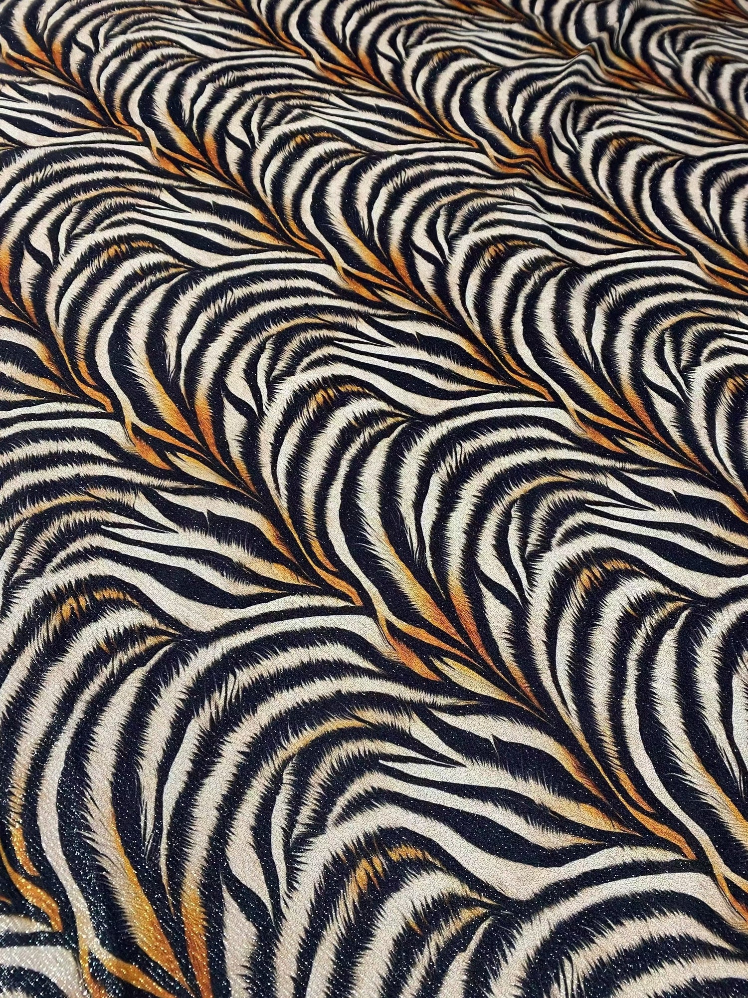 Gold Lurex Tiger Fabric with glittery tiger stripe pattern and 4-way stretch polyester knit