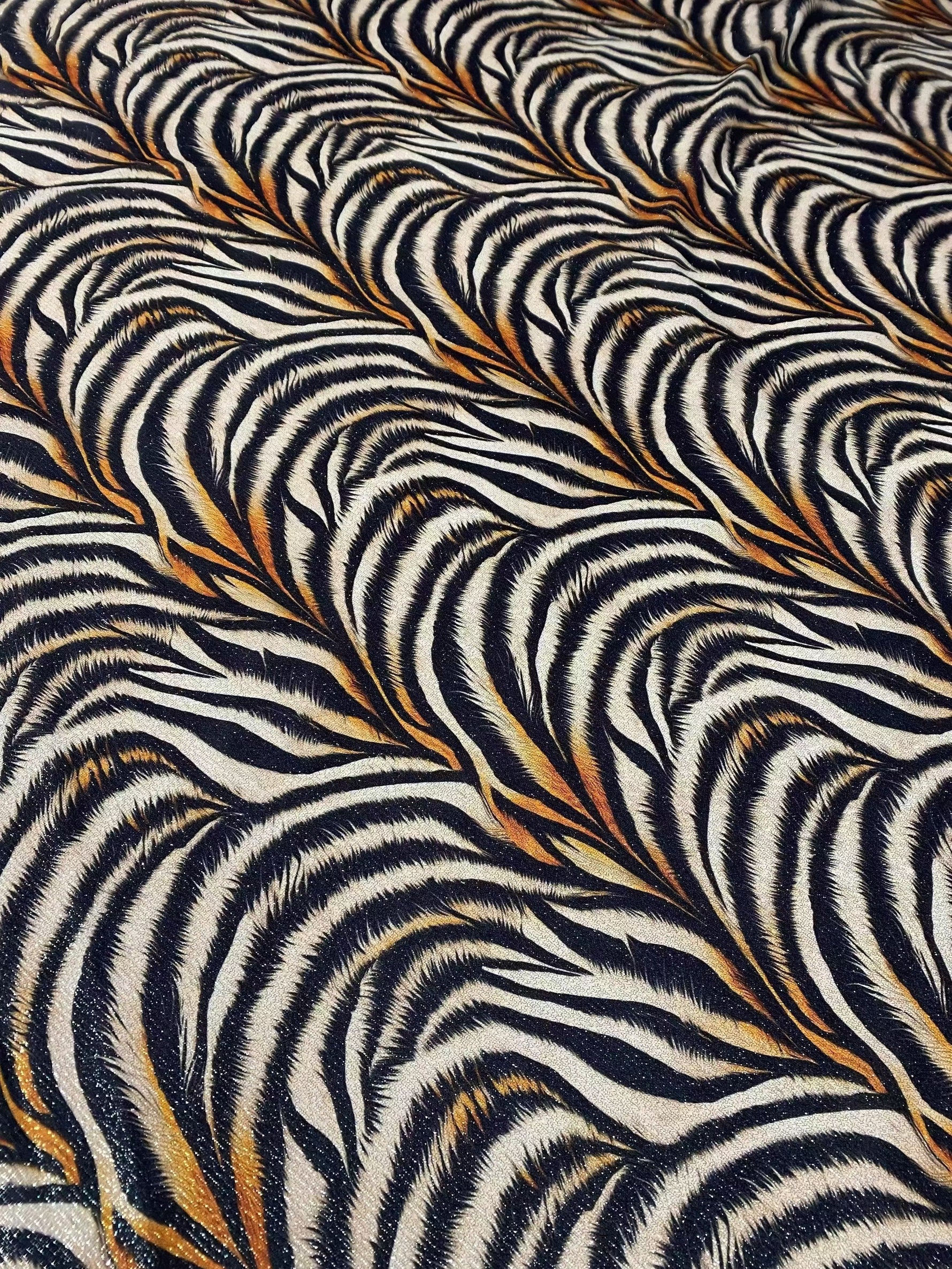 Gold Lurex Tiger Fabric with glittery tiger stripe pattern and 4-way stretch polyester knit