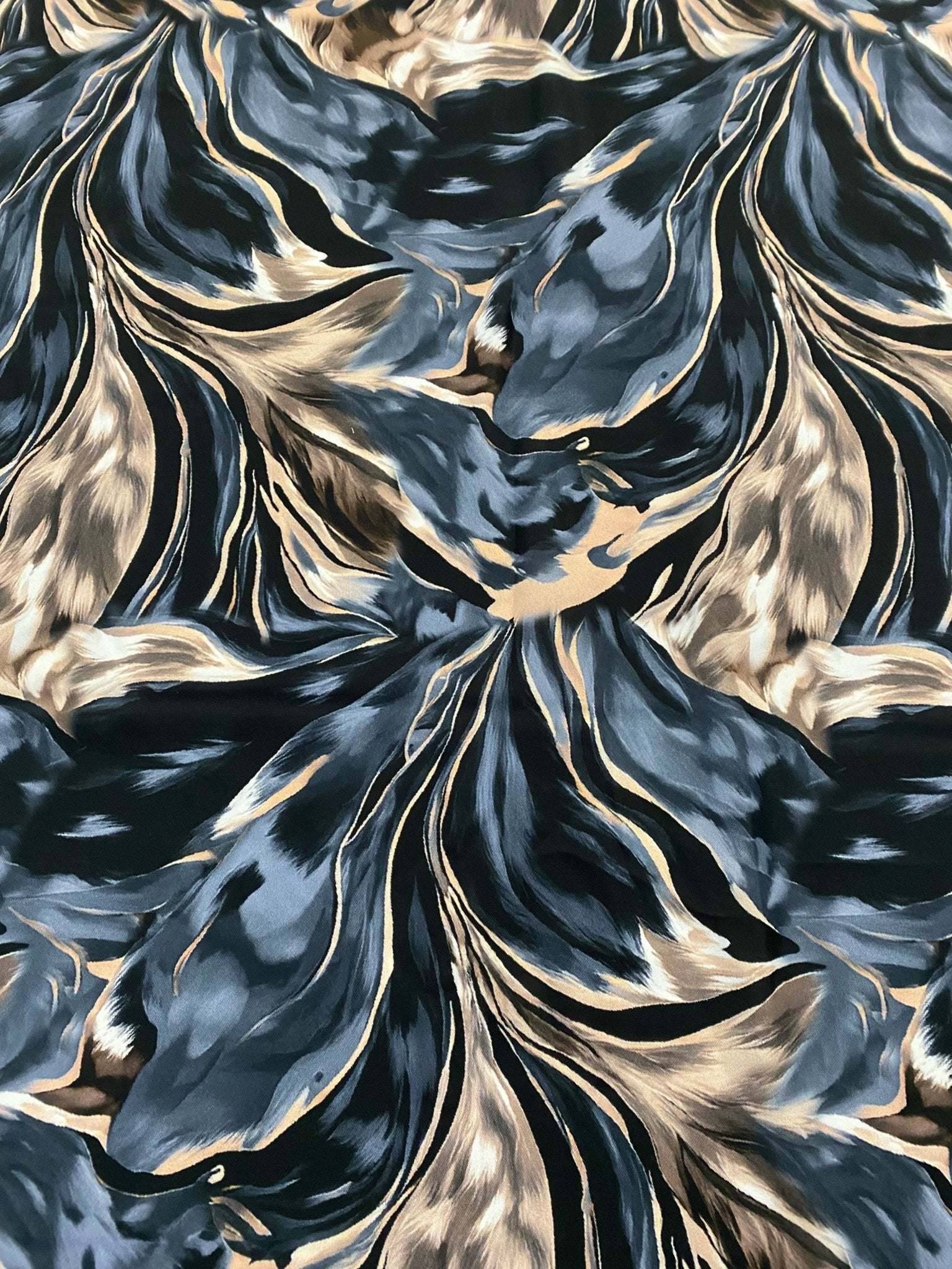 Abstract feather pattern fabric in black, beige, and blue with stylish flowing design