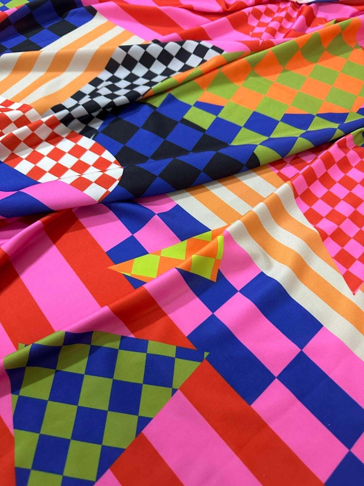 Multicolor abstract geometric fabric with vibrant checkerboard and stripe patterns in various bright colors and 150cm width