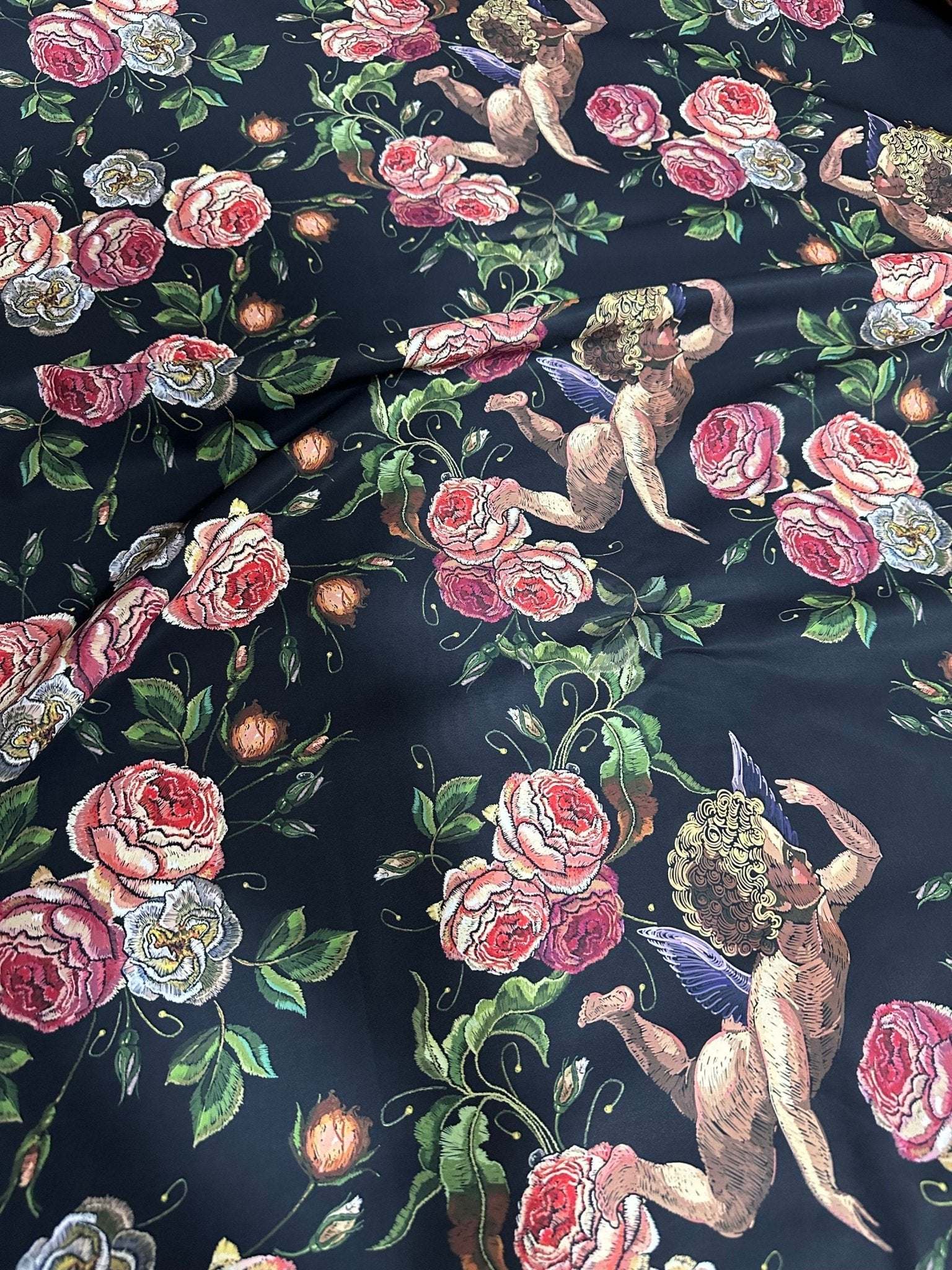 Angel Floral Print Fabric with cherubs and pink roses on black background, 150cm wide textile for sewing and crafting projects