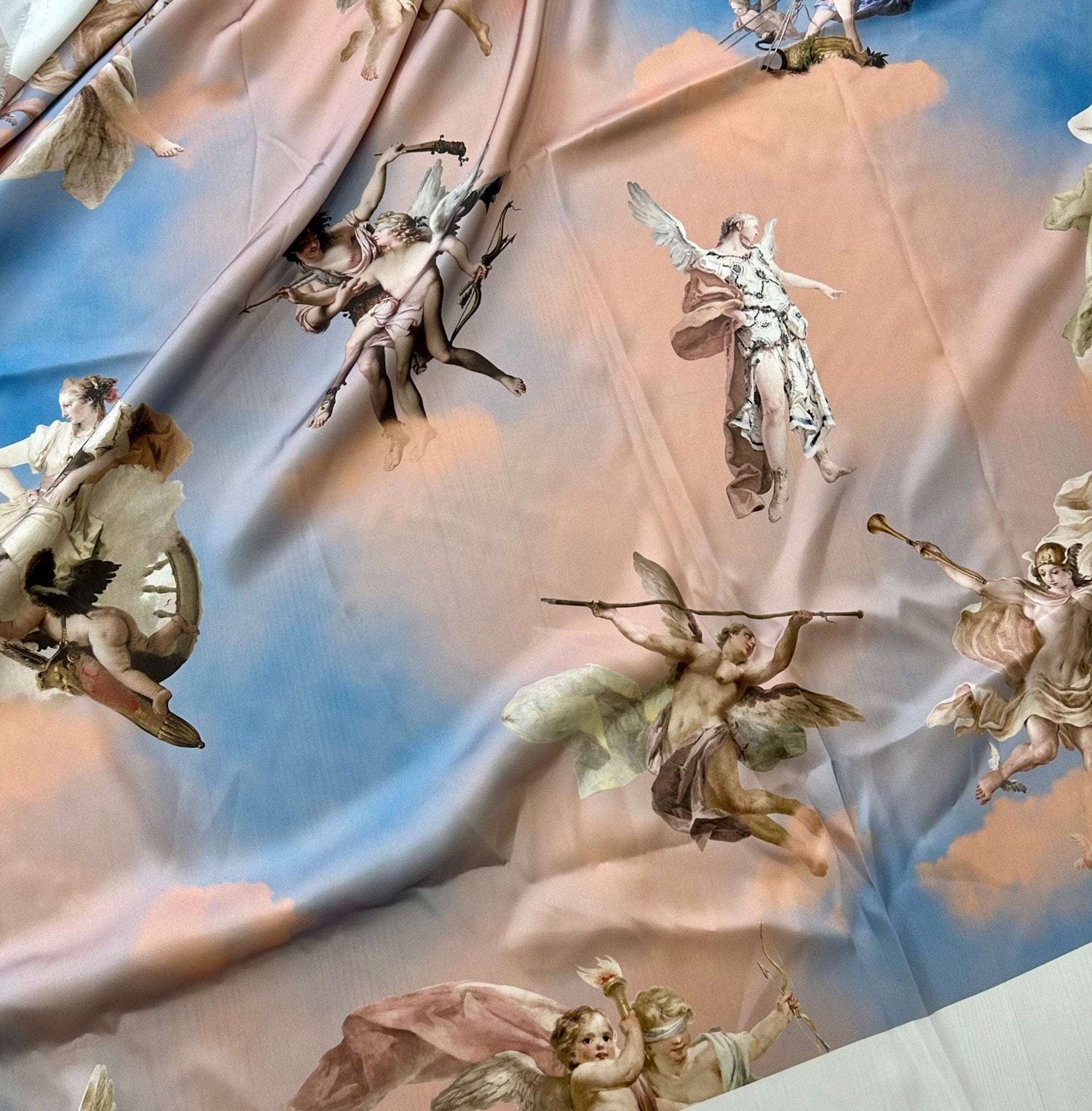 Sky blue fabric with angel print and cloud pattern for crafting and home décor projects