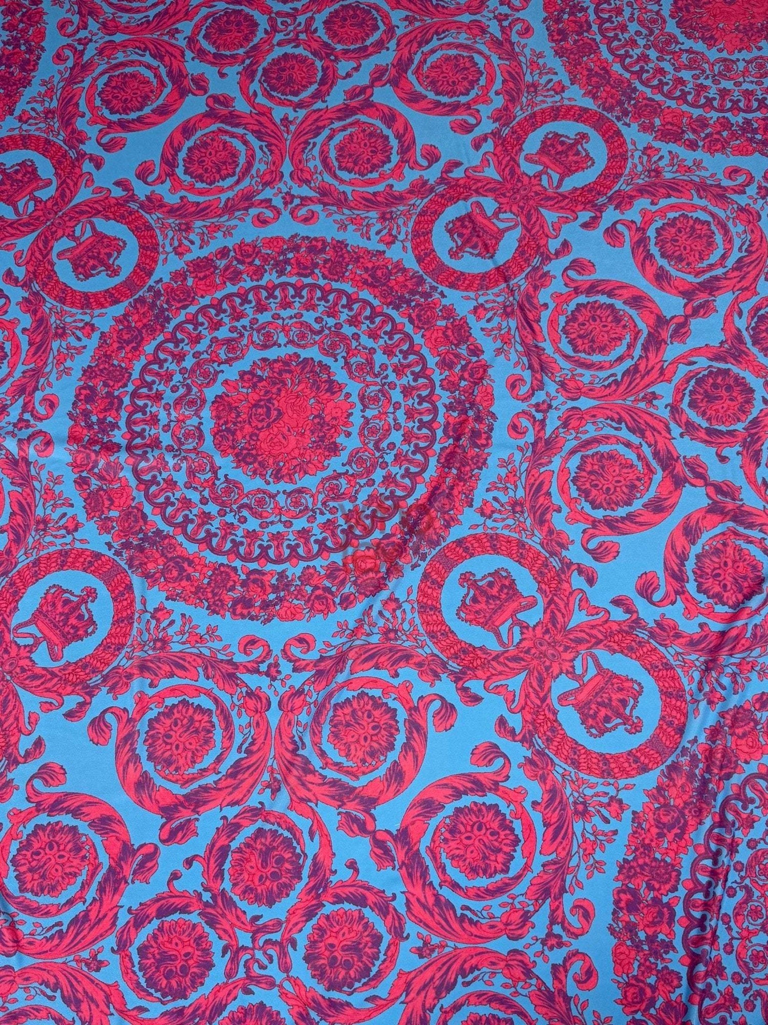 Blue fabric with intricate red baroque pattern design for upholstery and sewing projects