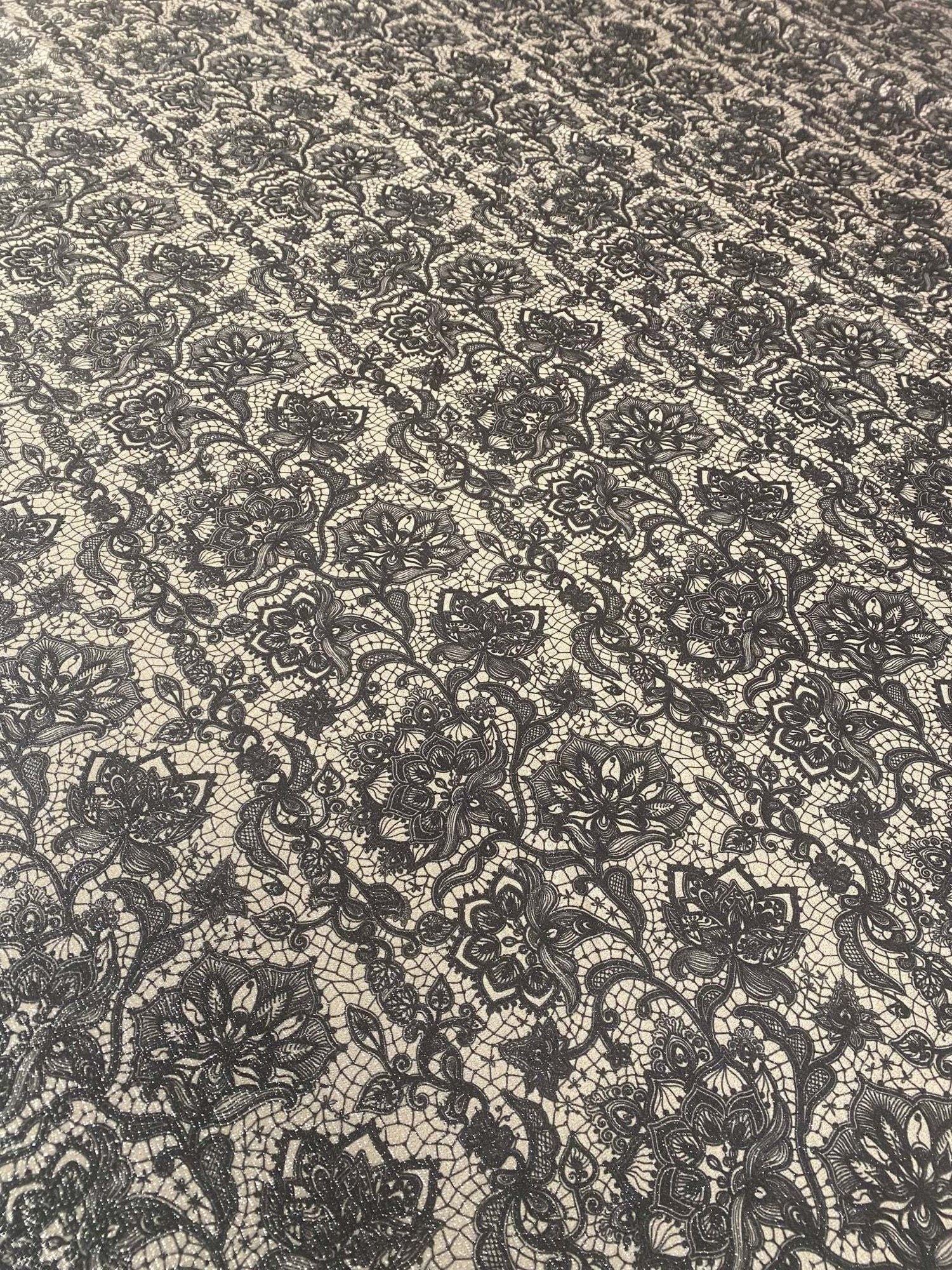 black floral lace fabric with intricate pattern on light background