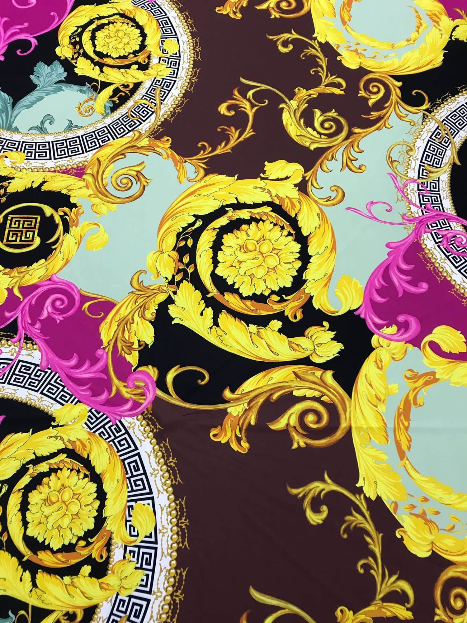 Black pink fabric with ornate Greek key print and gold floral swirls design
