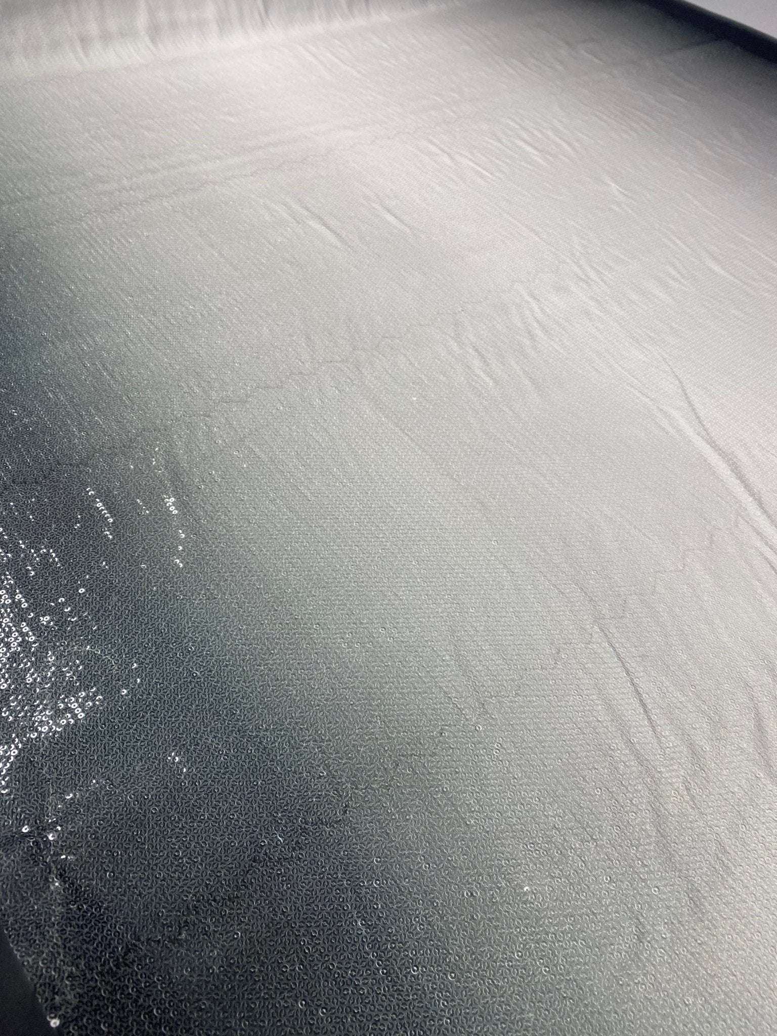 Black to white ombre sequin fabric with smooth gradient and subtle sparkle for fashion design