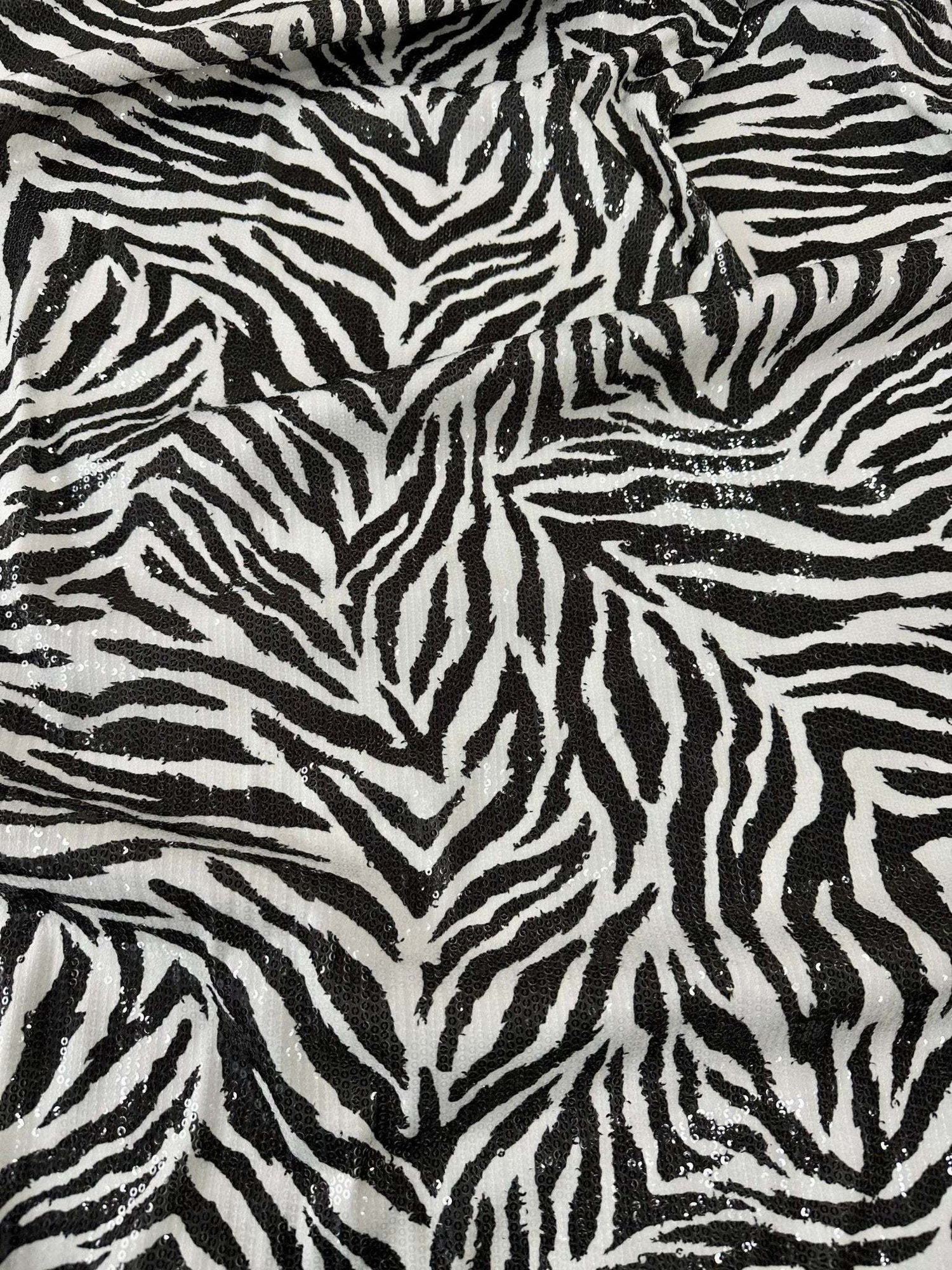 Black and white zebra sequin fabric with 2-way stretch for evening wear and fashion projects