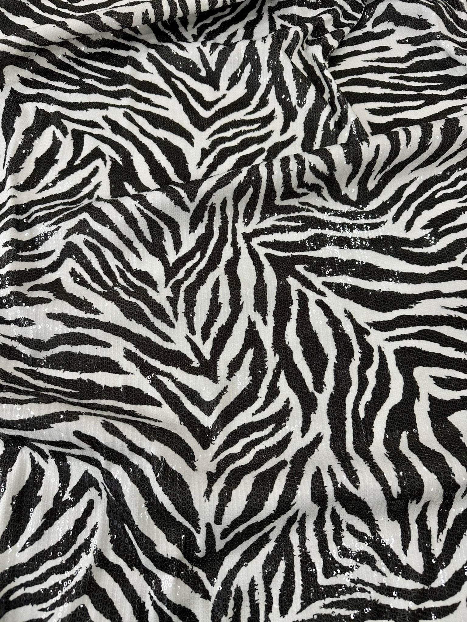 Black and white zebra sequin fabric with 2-way stretch for evening wear and fashion projects