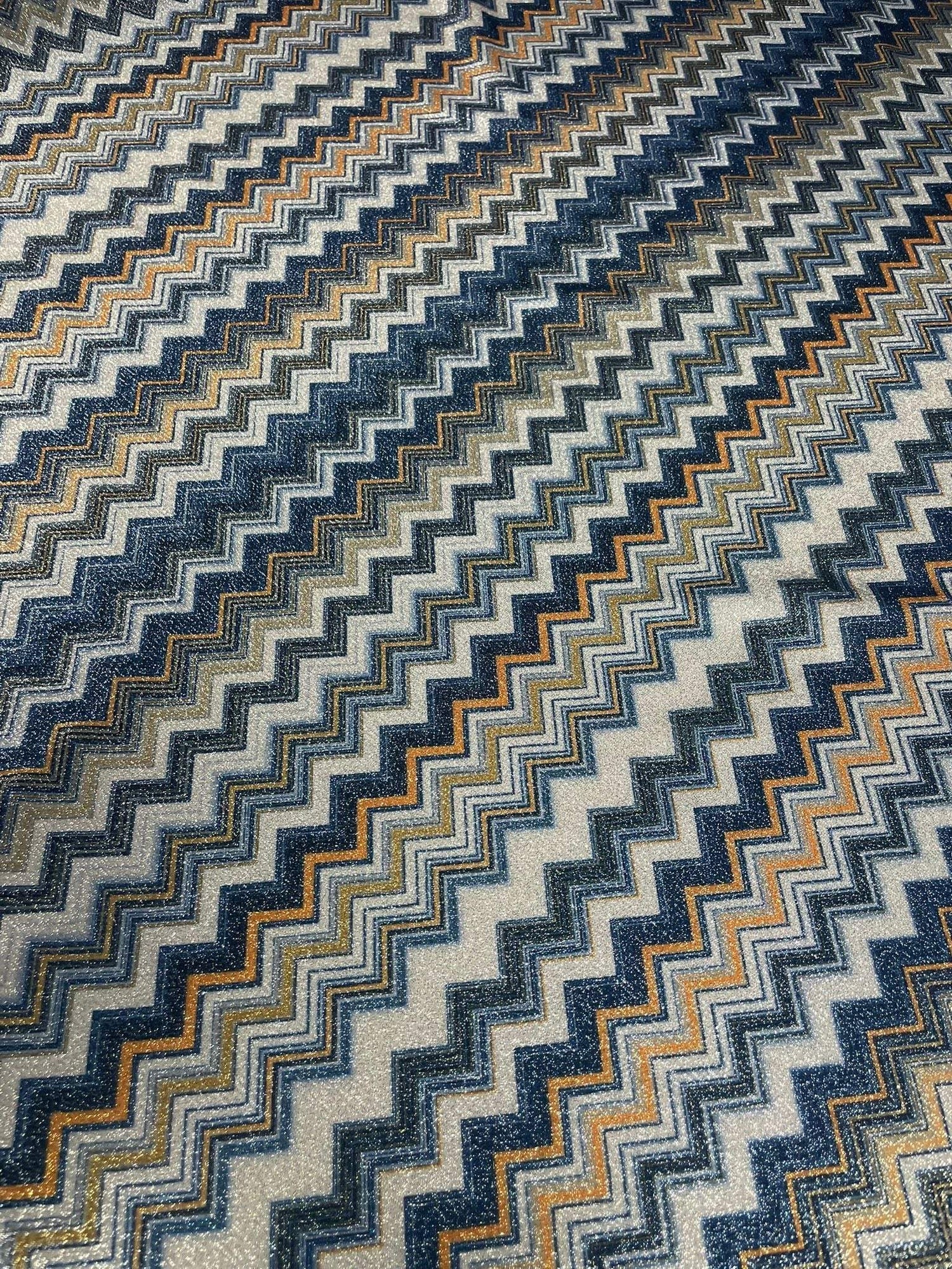 Gold Lurex striped glitter fabric with blue and orange zigzag pattern and 4-way stretch polyester blend