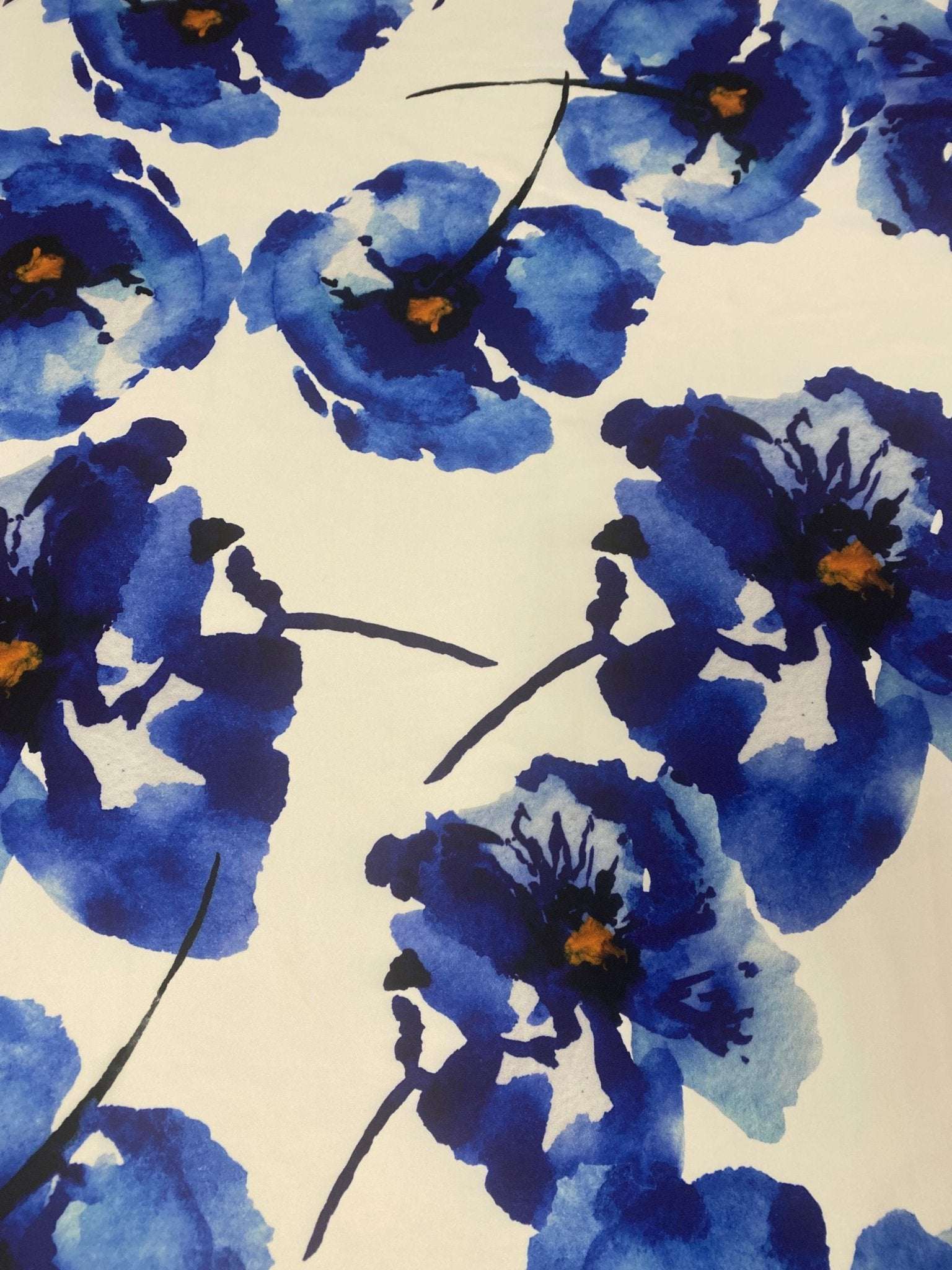 Bold blue watercolor floral fabric with vibrant blue flowers on a white background