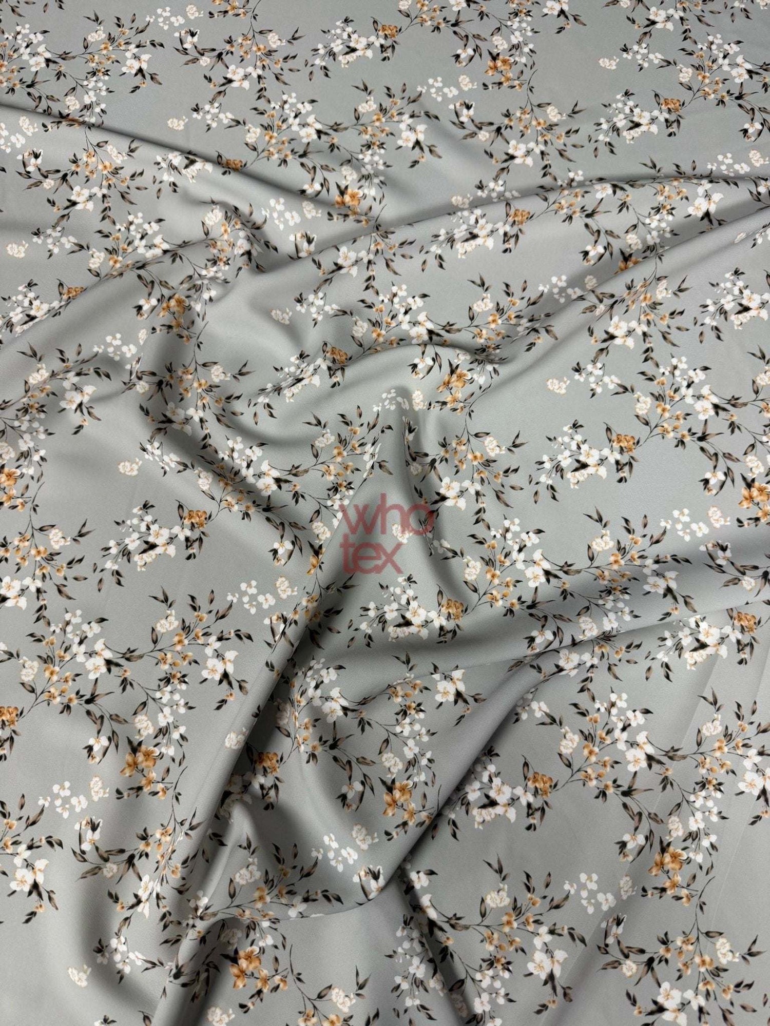 Soft fabric with delicate cherry blossom print in pastel colors on a light gray background