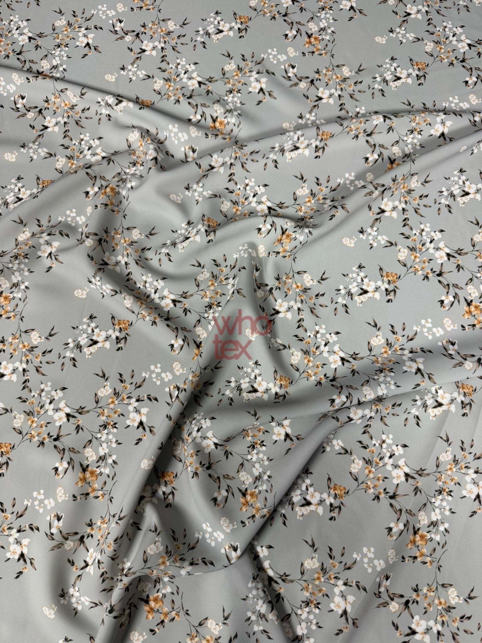 Soft fabric with delicate cherry blossom print in pastel colors on a light gray background