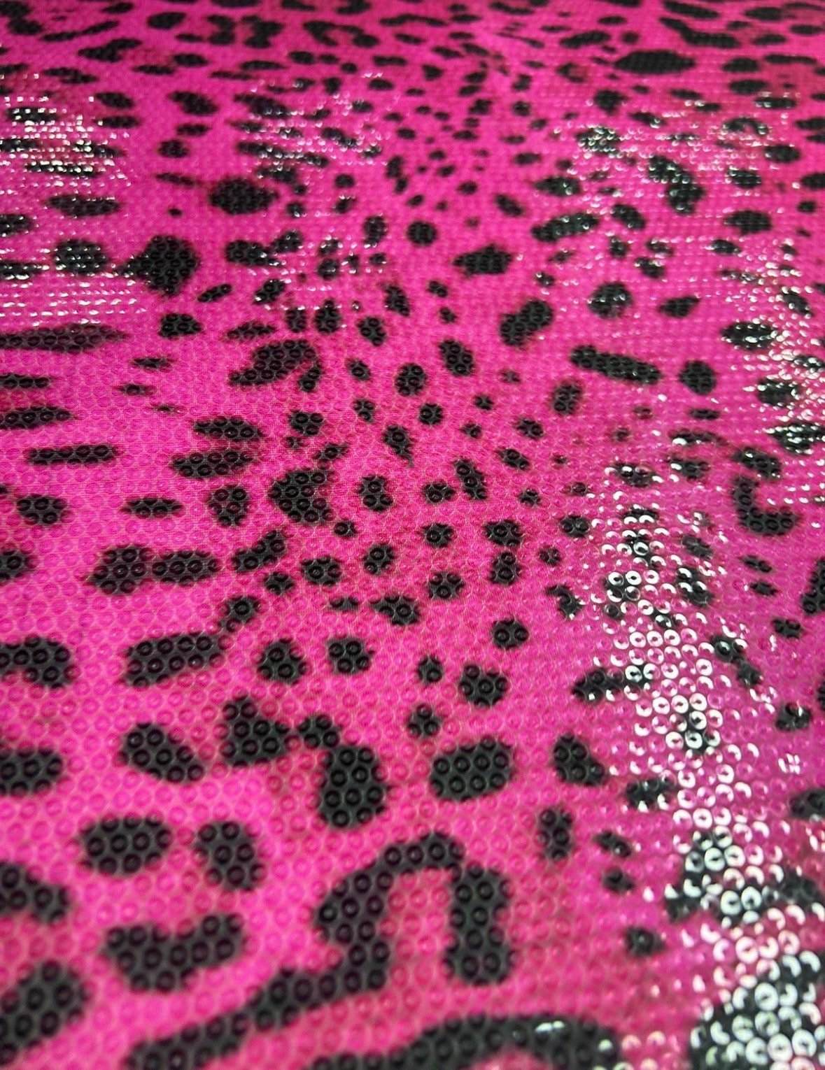 Fushia leopard print sequin fabric with two-way stretch for evening wear and fashion designs