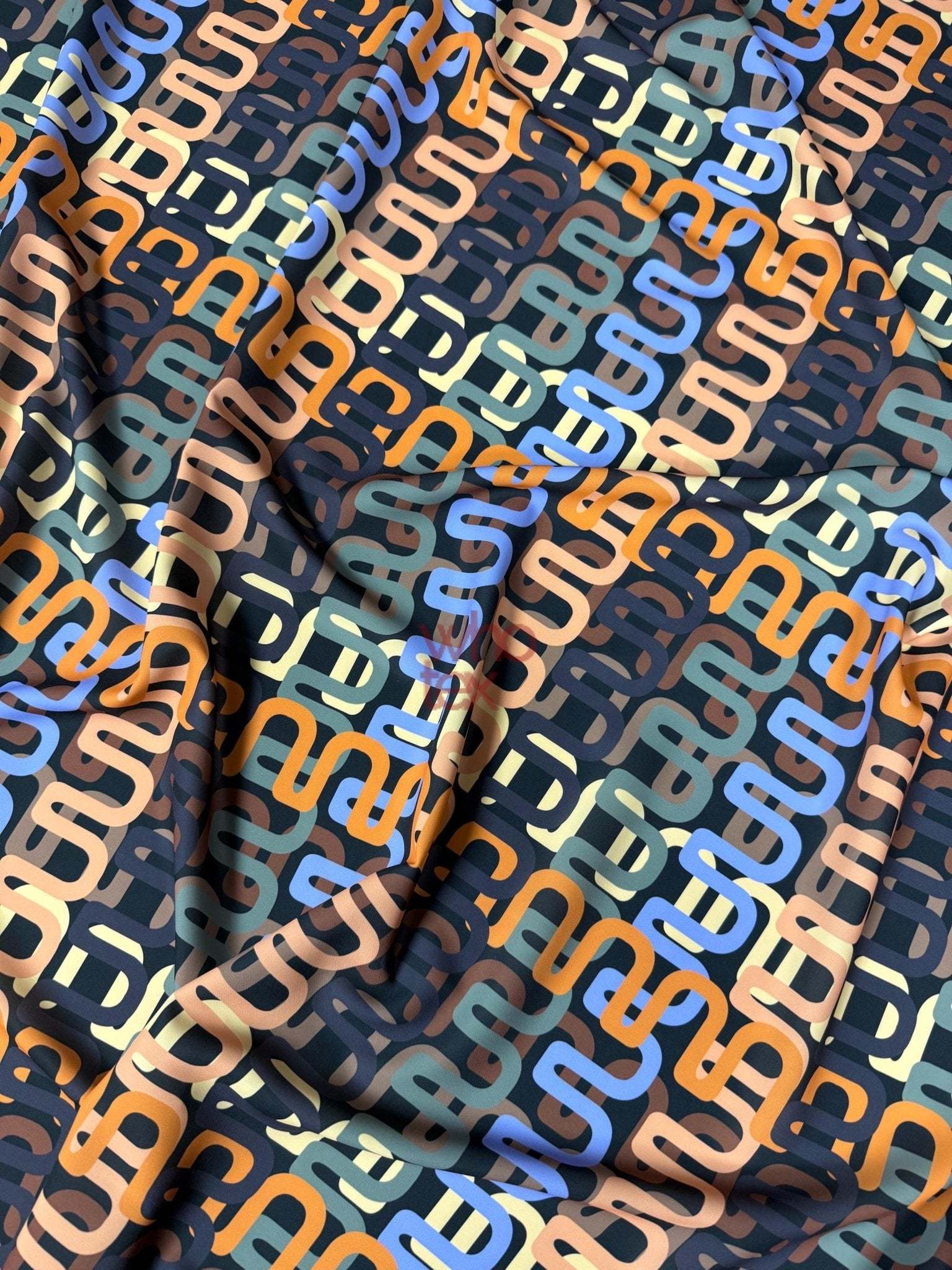 Geometric retro chain link pattern fabric with multicolor interlocking design on soft durable material