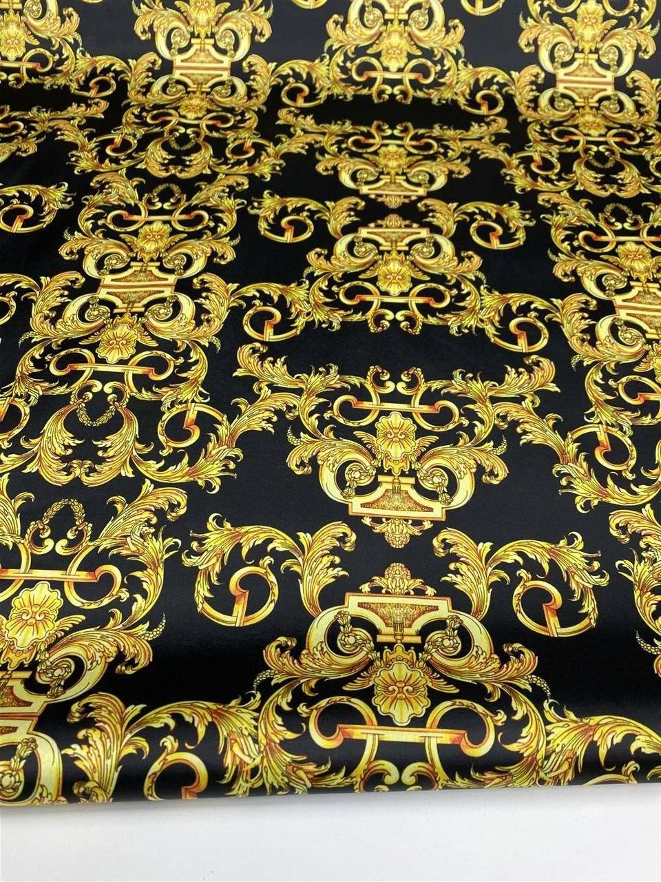 Luxurious black fabric with intricate gold baroque pattern for elegant upholstery and drapery