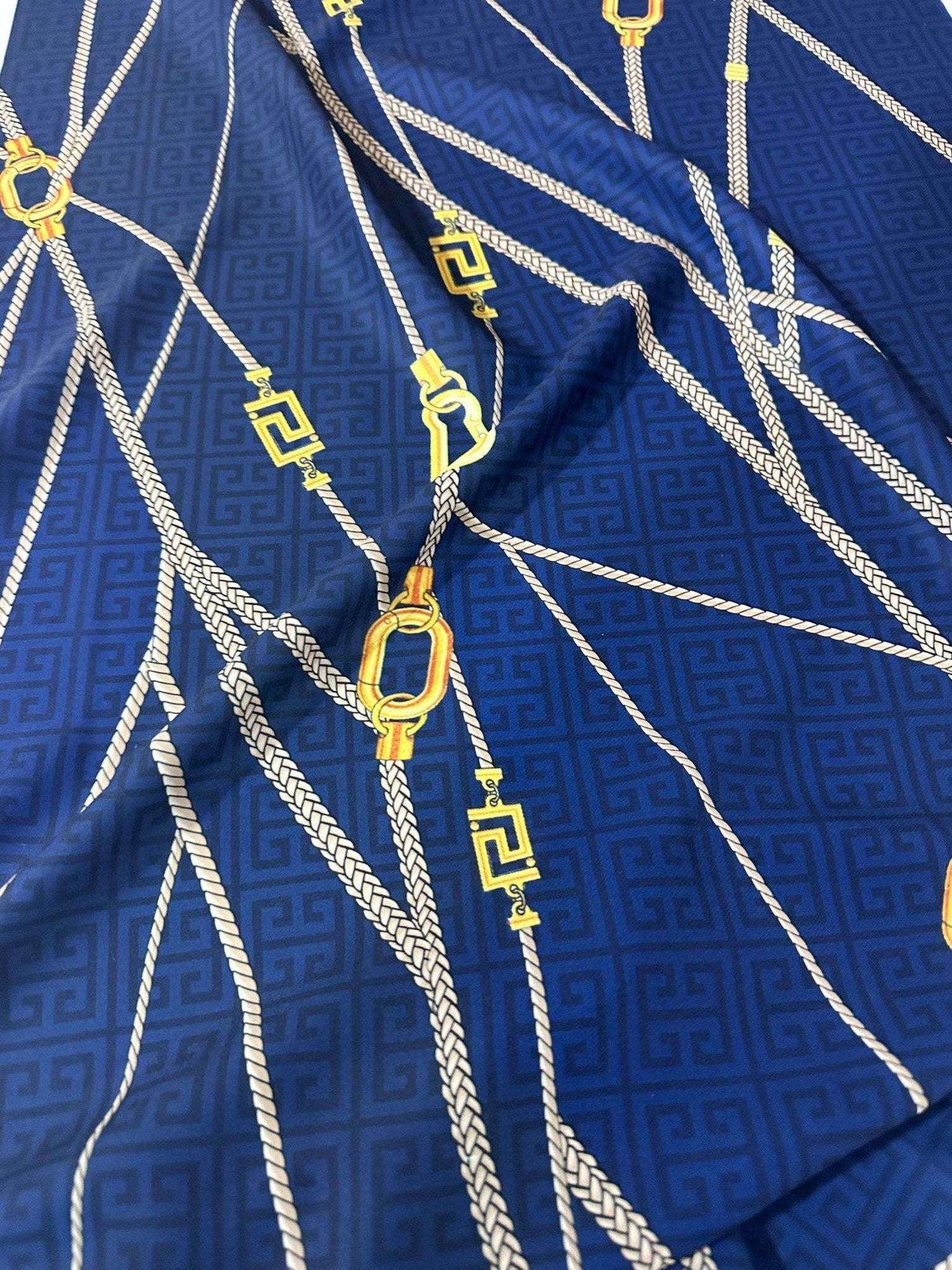 Navy blue fabric with Greek key pattern and rope design for fashion and décor projects