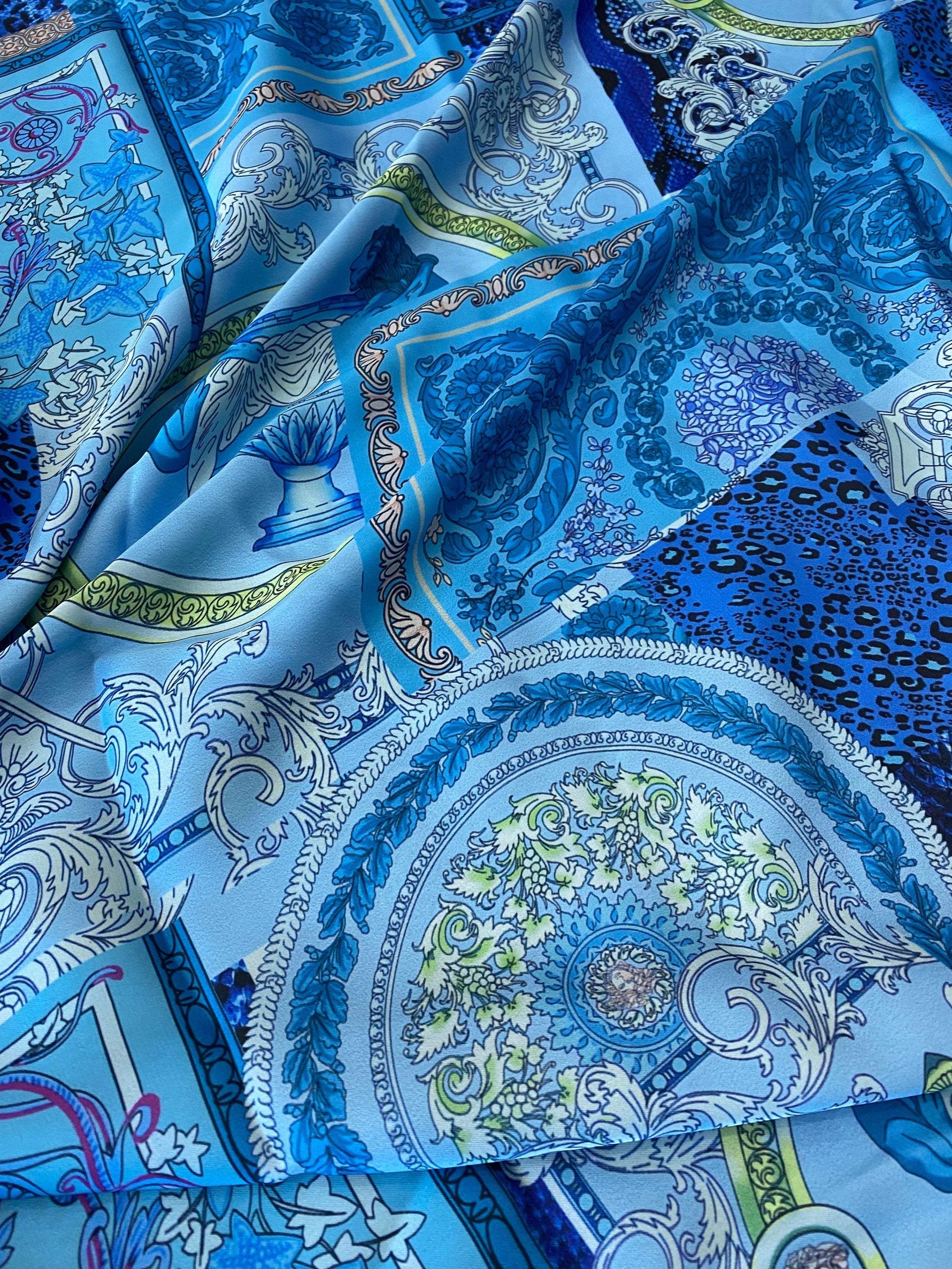 close-up of navy blue baroque pattern fabric with intricate ornate designs and various shades of blue