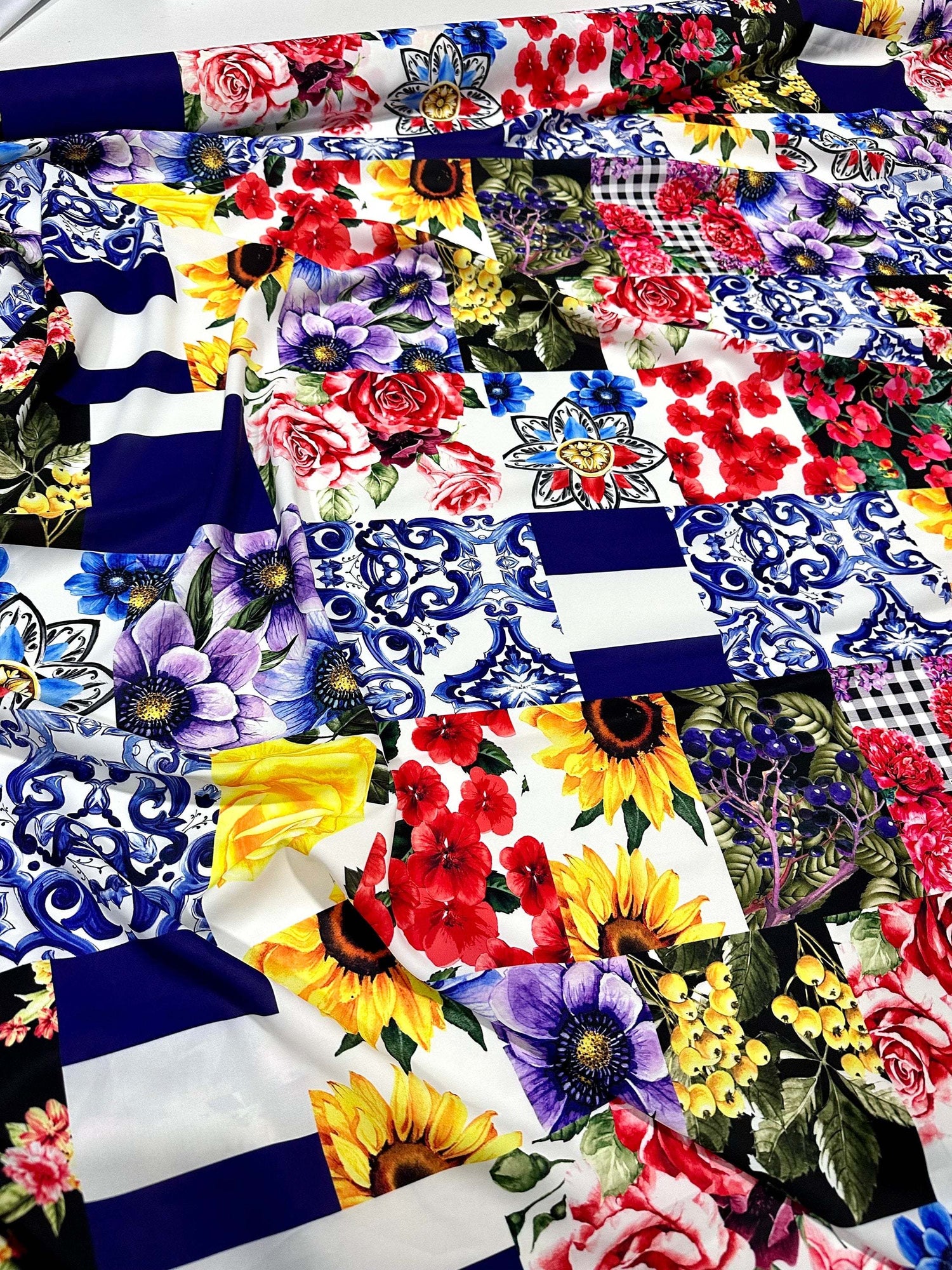 Majolica pattern fabric with vibrant floral and traditional tile designs in blue, red, yellow, and purple on a 150cm wide cloth