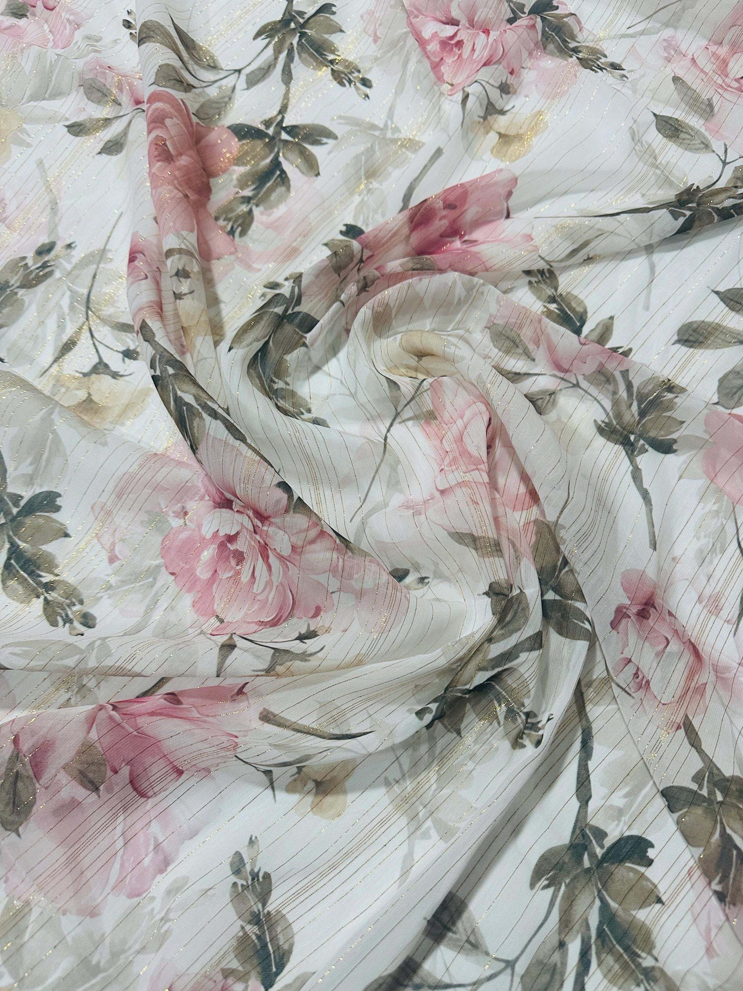 Gold striped floral print chiffon fabric with pink flowers and green leaves on a white background