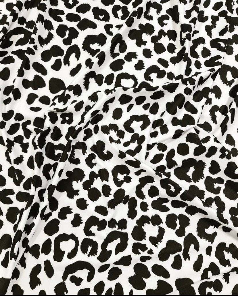 Black and white leopard print fabric with 150cm width, ideal for clothing and decor projects