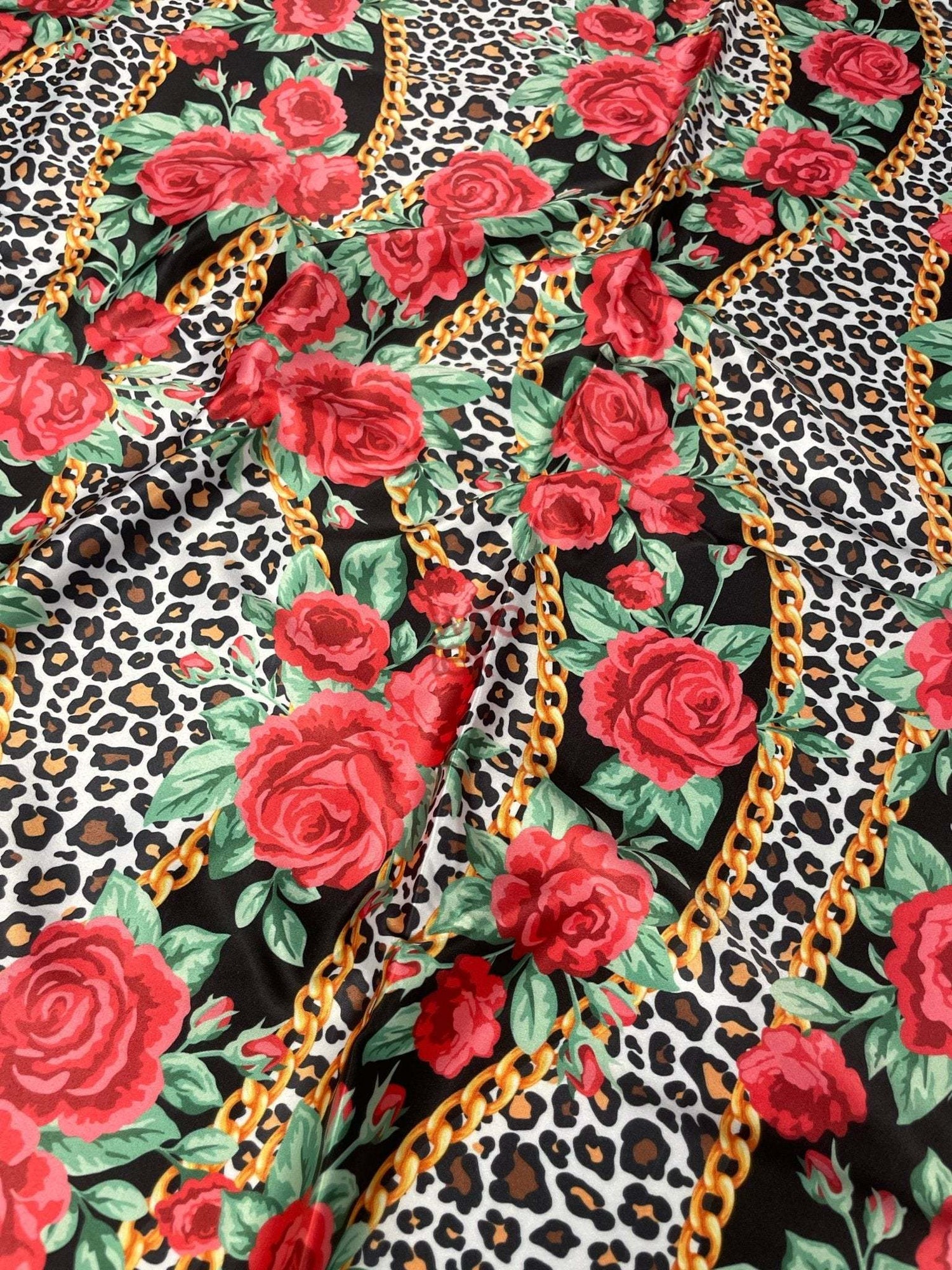 Leopard print fabric with red roses and gold chain patterns for sewing projects
