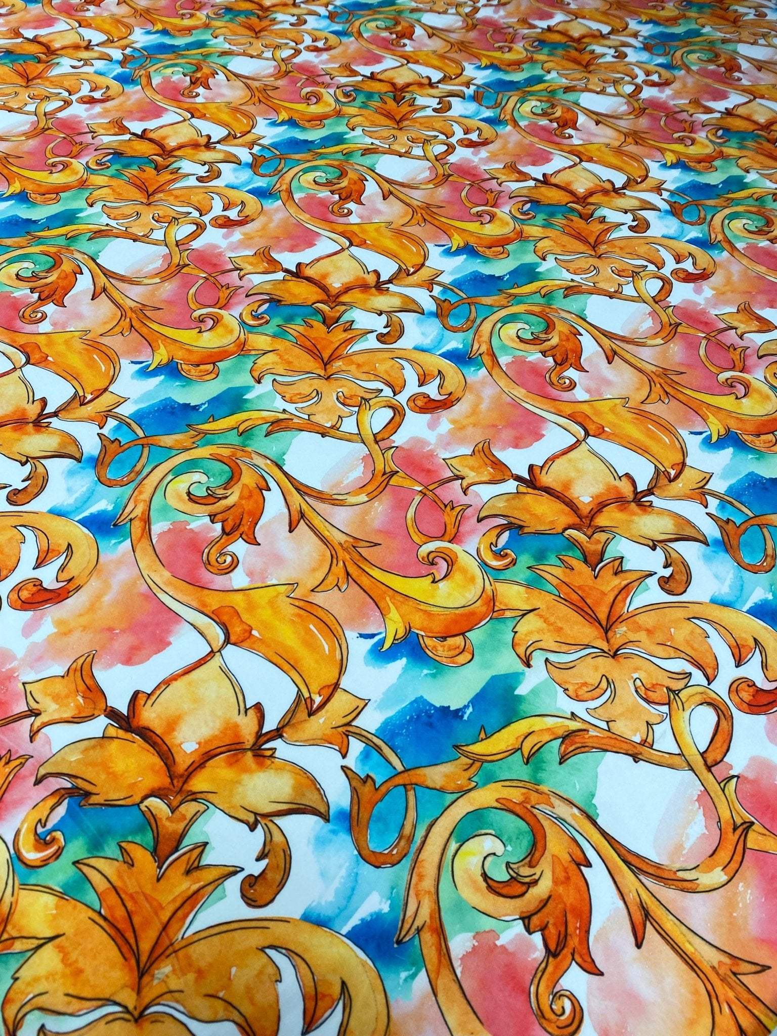 Luxury ornate medallion and chain print fabric with vibrant orange, blue, and pink watercolor background, ideal for sewing and decor projects