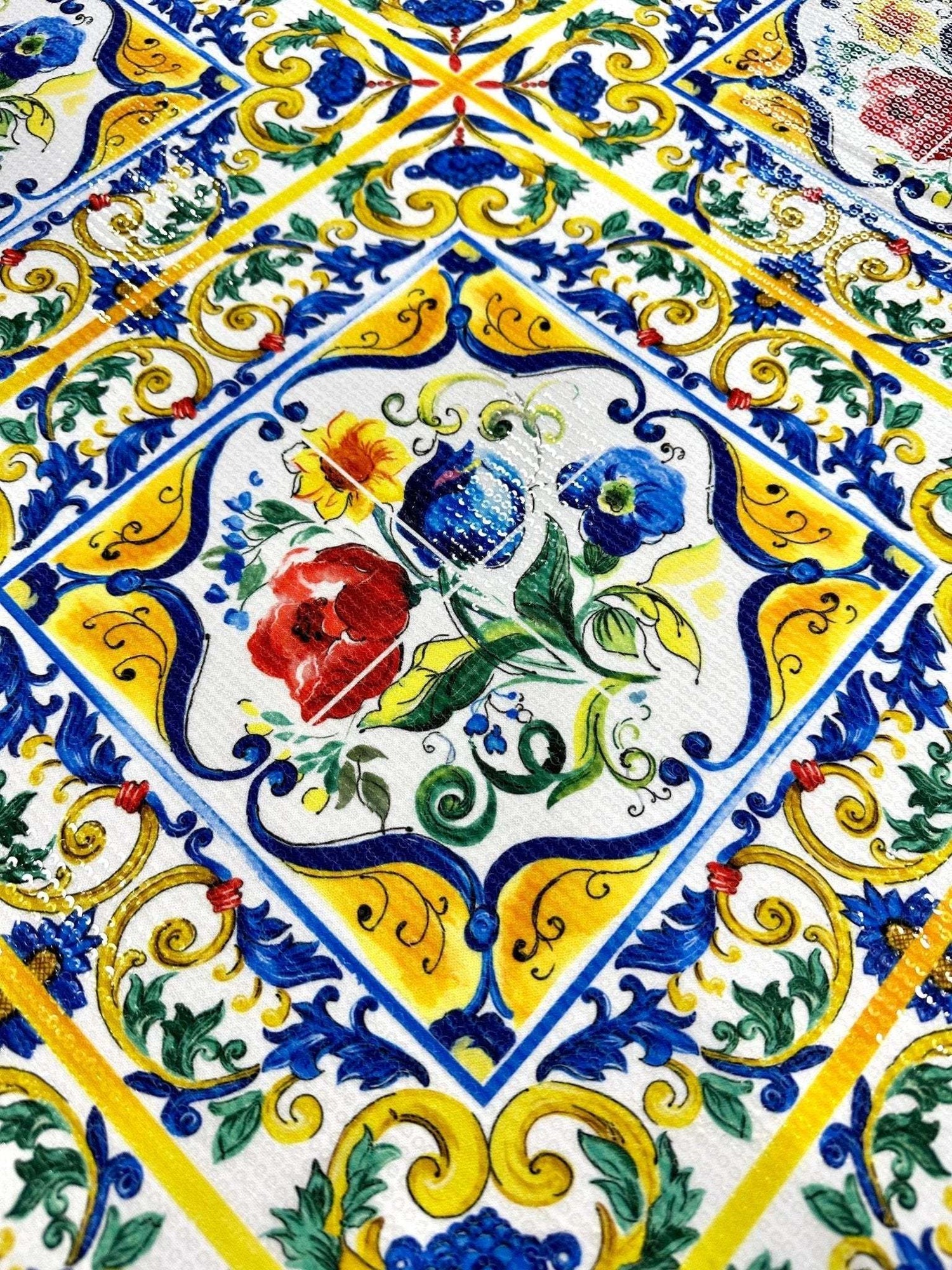Majolica pattern sequin fabric with vibrant floral and geometric designs in yellow, blue, red, and green, featuring shimmering sequins and two-way stretch.