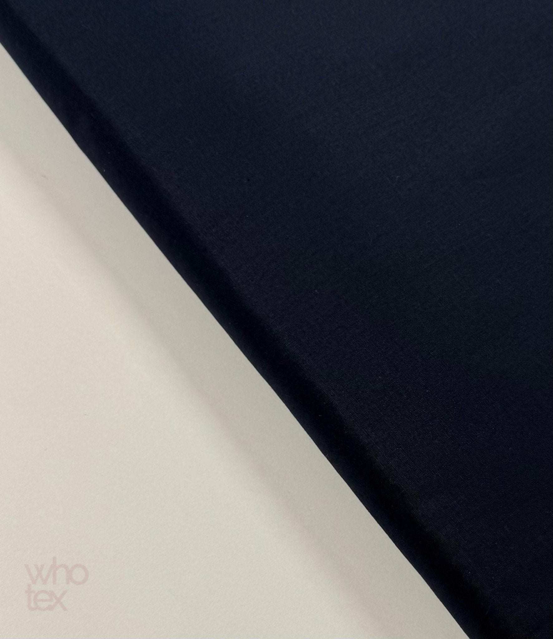 Navy blue 100% cotton poplin fabric folded on a light background with smooth texture and 240 cm width suitable for bedding and apparel.