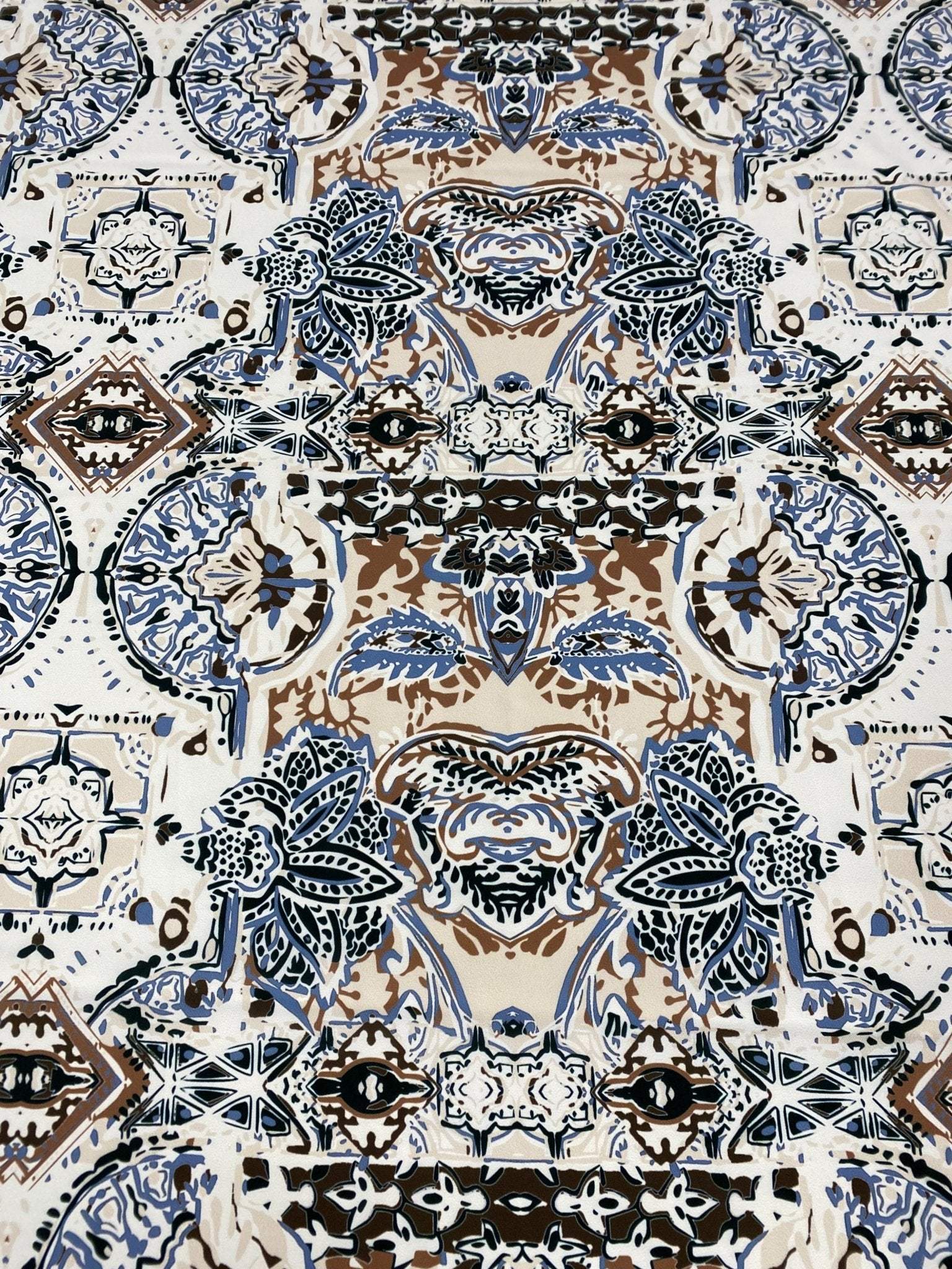 Ornamental ethnic print fabric in blue, brown, and beige with intricate patterns and 150cm width