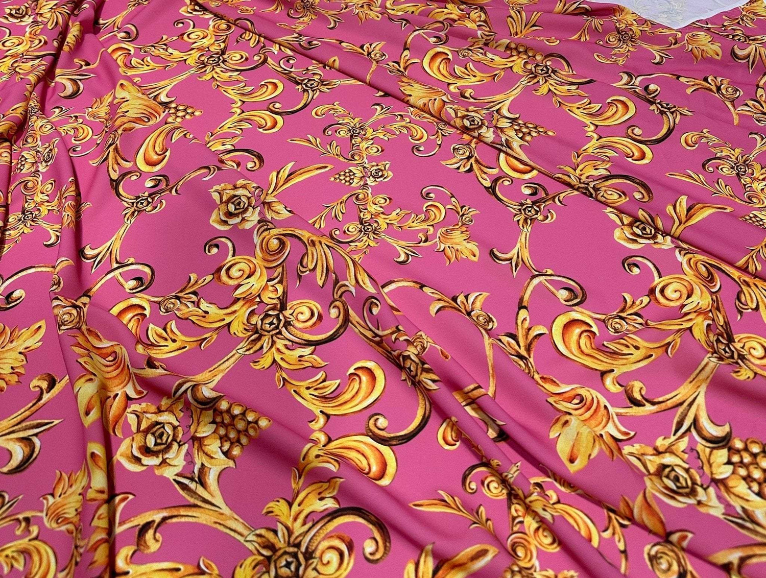 Pink and gold Baroque print fabric with elegant floral and scroll patterns for upholstery and decorative projects