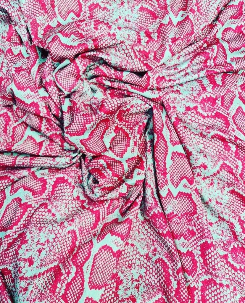 Pink and white snake skin patterned fabric with vibrant colors and 150cm width for fashion and home decor projects