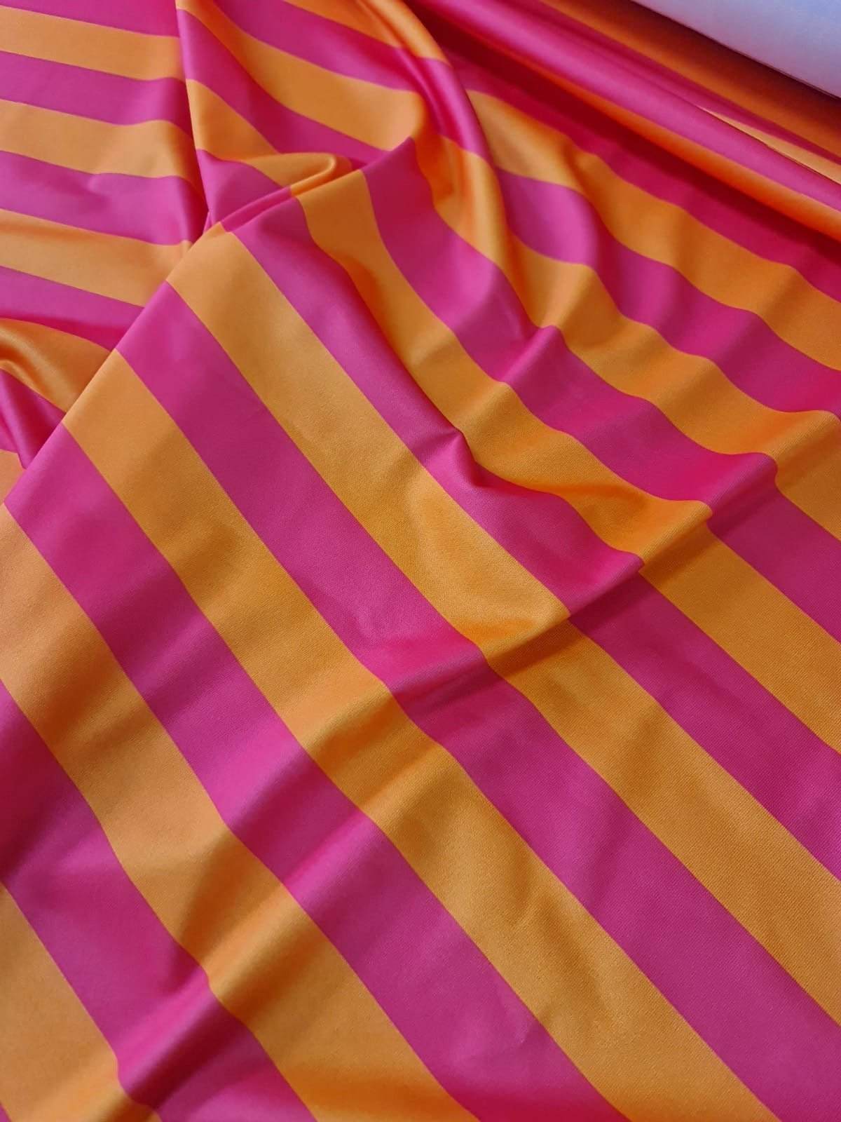 Orange pink striped stretchy lycra fabric with vibrant color and excellent elasticity ideal for clothing and crafts