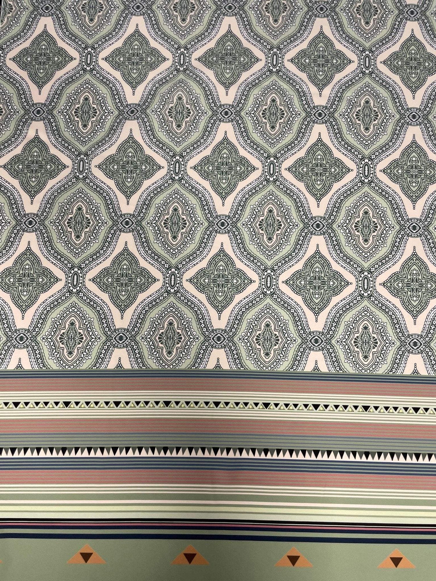 Soft green and pink fabric with ethnic pattern and border stripes for sewing projects