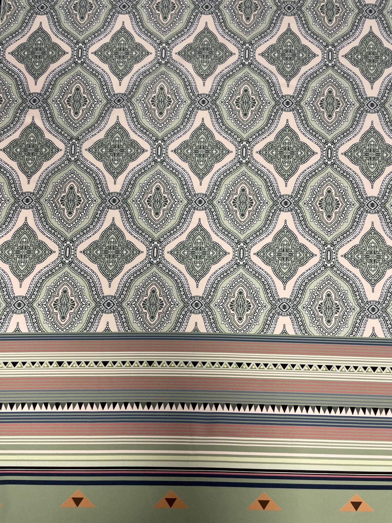 Soft green and pink fabric with ethnic pattern and border stripes for sewing projects