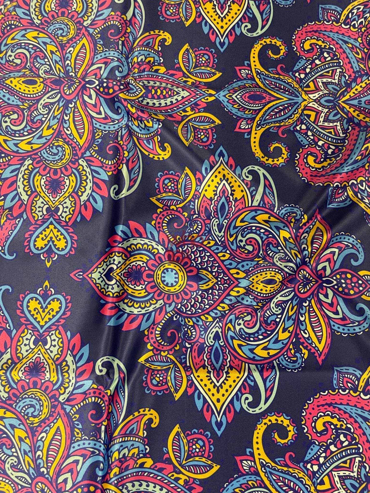 Vibrant Bohemian paisley fabric with colorful intricate patterns on dark background