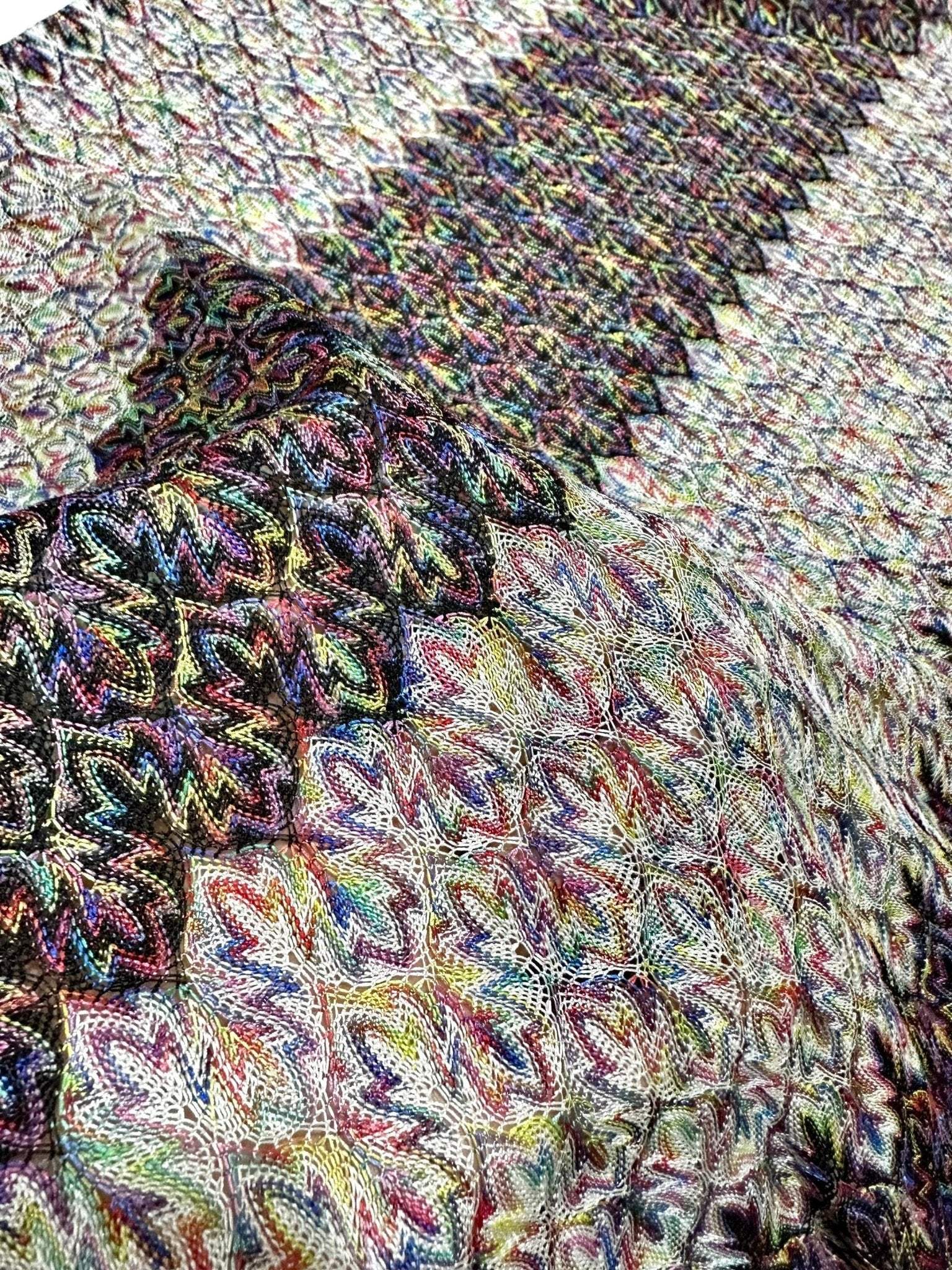 Black and white zigzag knit jersey fabric with colorful pattern details and soft texture