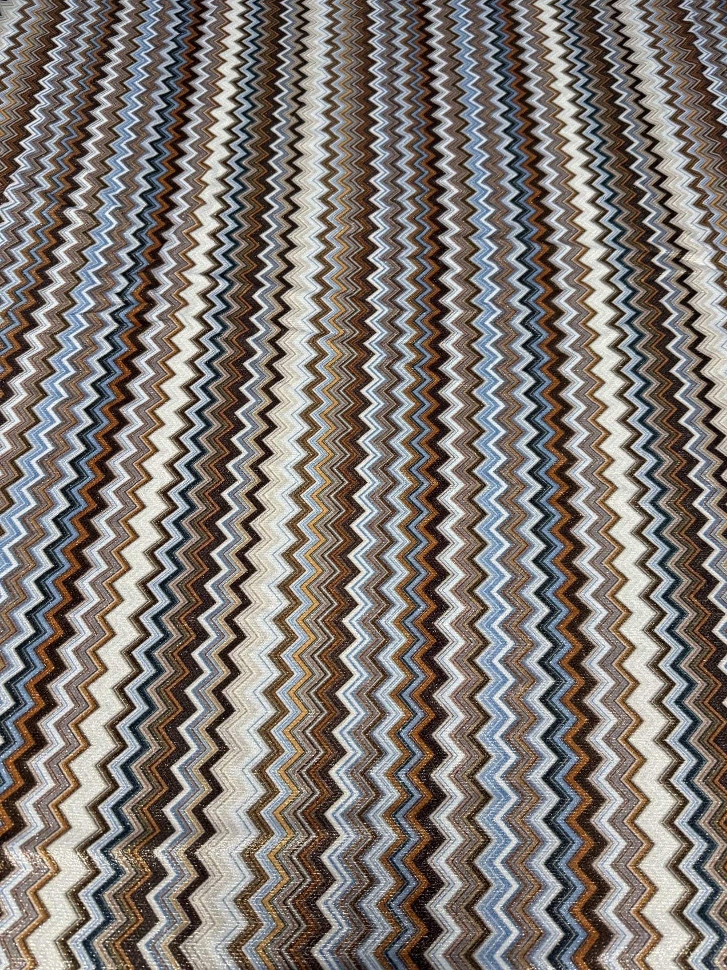 Zigzag Lurex Knit Fabric with shimmering zigzag pattern in blue, brown, and white colors, 4-way stretch for versatile use in garments